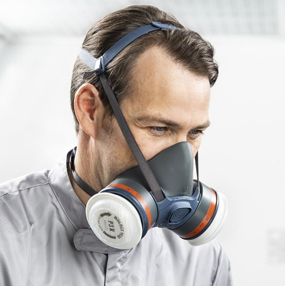 Worker wearing the Moldex 7432 half face respirator mask with ABEK1P3 filters in drop-down position around the neck