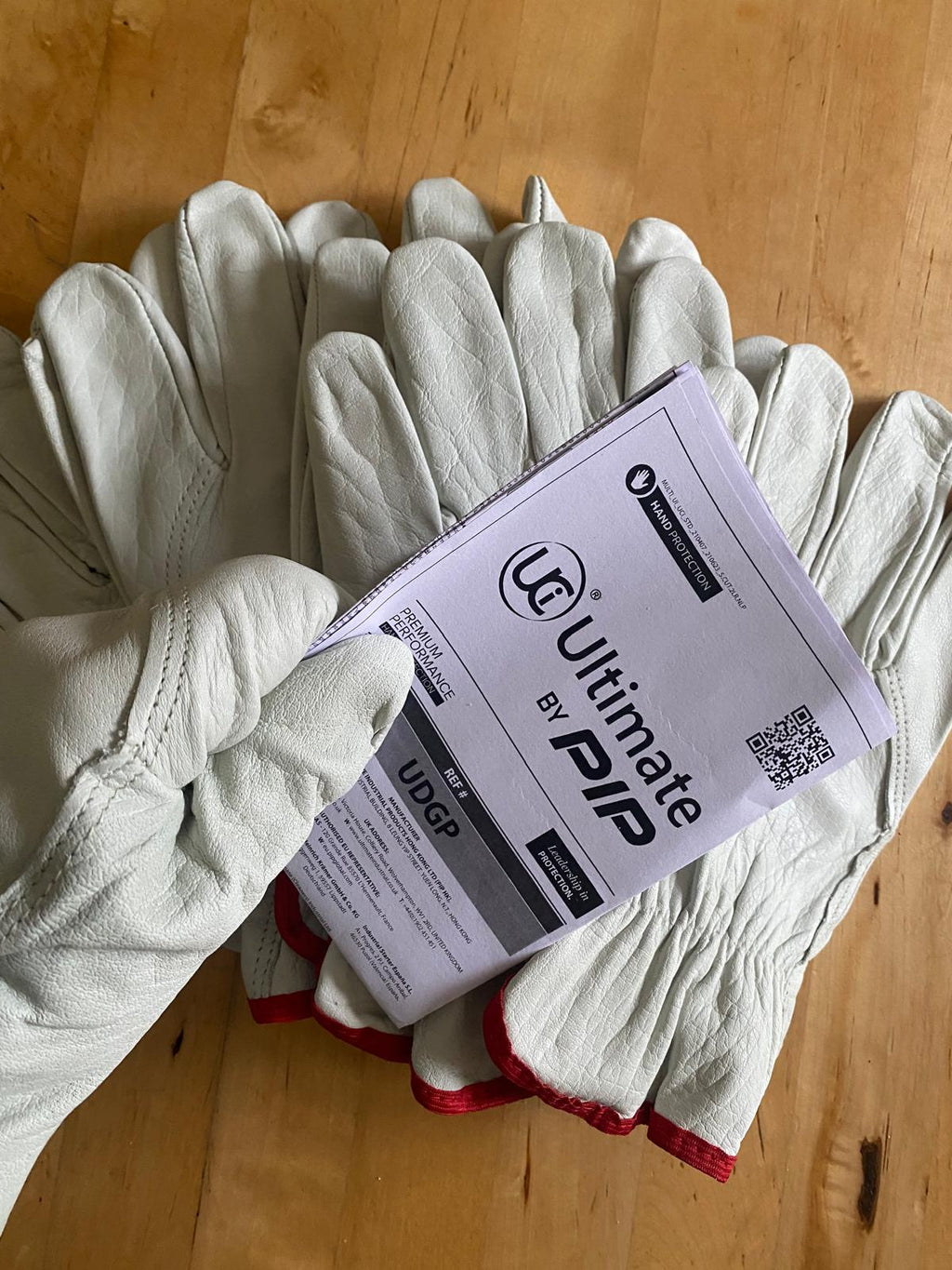 Ultimate by PIP UDGP leather drivers gloves with product label