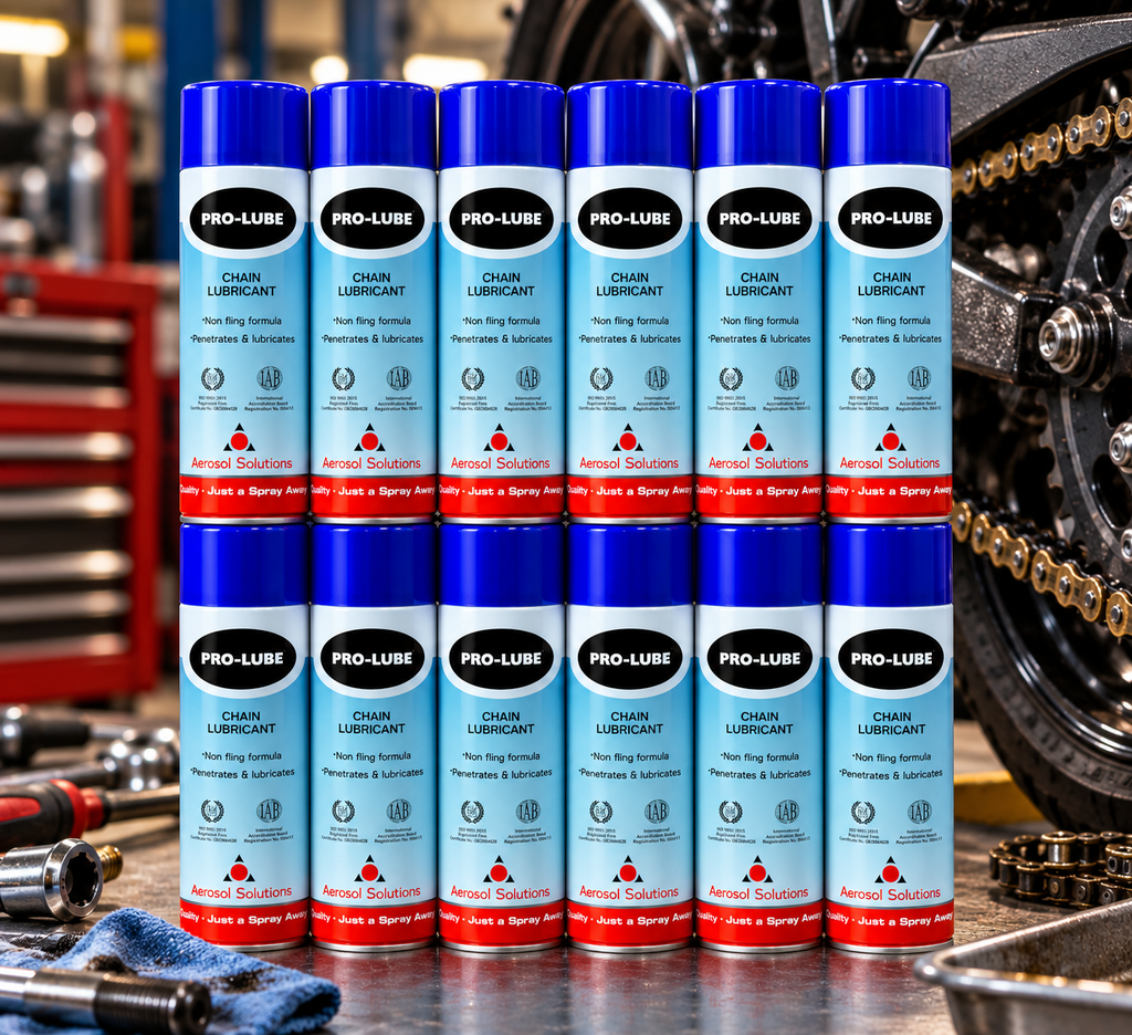 Box quantity of twelve Aerosol Solutions Pro-Lube Chain Lubricant 500ml cans displayed beside a motorcycle chain